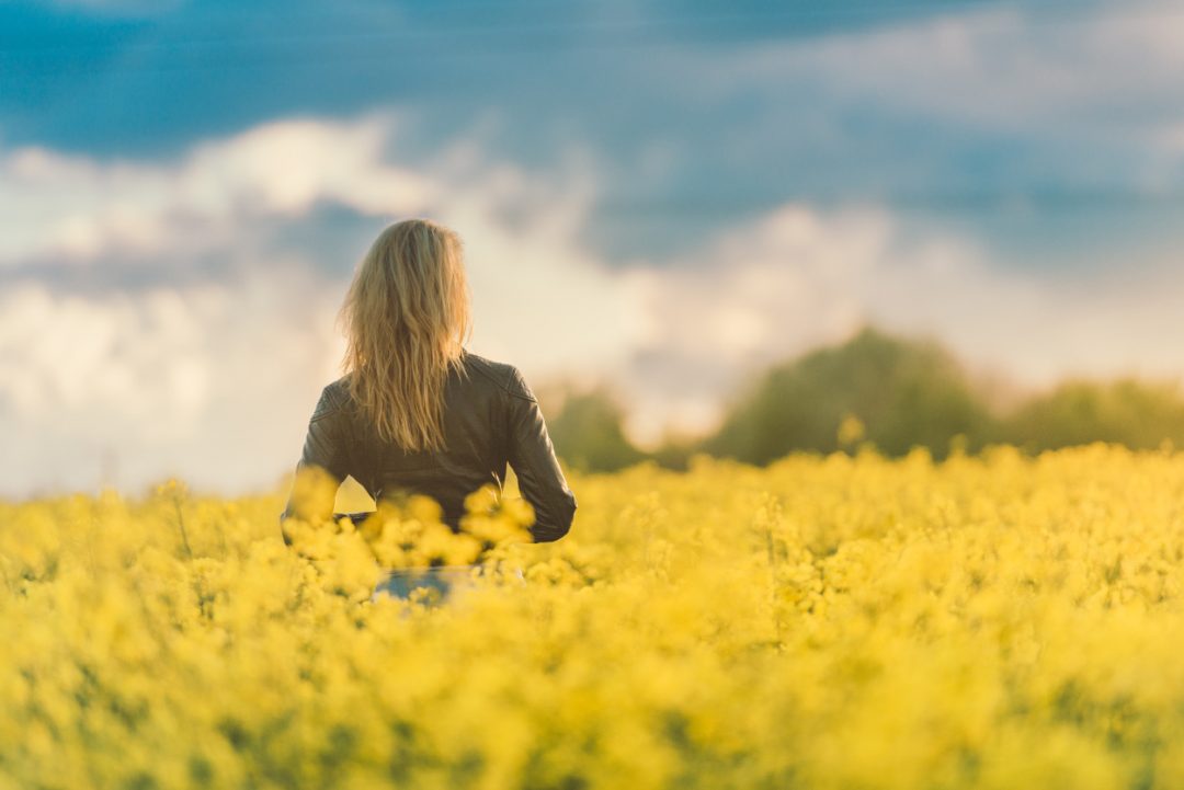 Girl Standing In Field Of Flowers At Sunset - Aifc