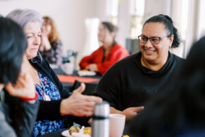 Counsellor engaging with diverse clients in a culturally sensitive counselling session.